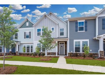 Charming townhomes featuring various blue and gray color schemes, stone accents, and professionally landscaped yards at 10105 Mamillion Dr, Huntersville, NC 28078