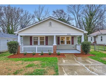 Charming single-story home featuring a cozy front porch with brick accents and a well-maintained lawn at 3004 Ridge Ave, Charlotte, NC 28208