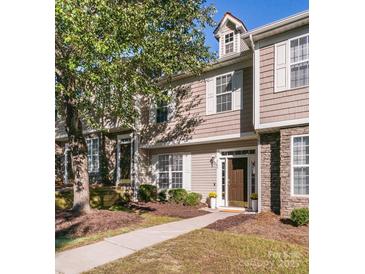 Charming townhome with neutral siding, stone accents, well-maintained landscaping, and inviting walkway at 563 Goldstaff Ln, Charlotte, NC 28273