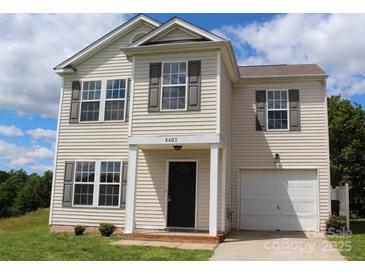 Charming two-story home with a tidy front yard and an attached garage, perfect for comfortable living at 8403 Spirea Ct, Charlotte, NC 28215