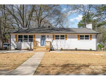 Charming white brick ranch with blue door, light wood accents, and a well-manicured front yard at 919 N Weldon St, Gastonia, NC 28052