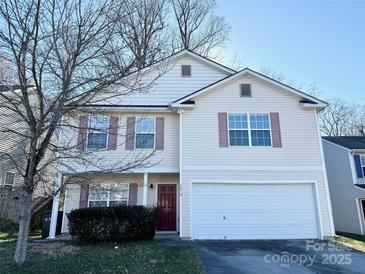 Charming two-story home with a white garage door and well-maintained landscaping at 1239 Jordans Pond Ln, Charlotte, NC 28214