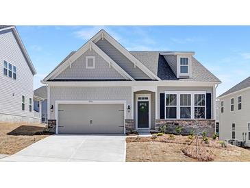 Charming single-Gathering home features a two-car garage, stone accents, and a welcoming front entrance with a wreath at 5096 Silver Creek Ln, Denver, NC 28037