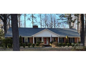 Charming brick home with a well-manicured lawn and mature trees offering great curb appeal at 5444 Marengo Cir, Charlotte, NC 28216