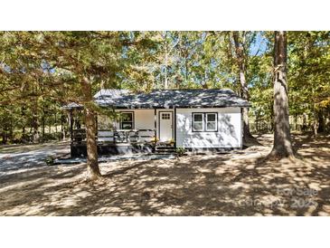 Charming white cottage with black accents and a front porch at 1473 Polk Ford Rd, Stanfield, NC 28163