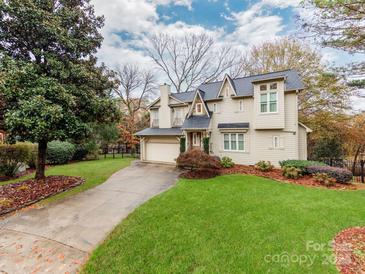 Two-story house with attached garage and manicured lawn at 501 River Oaks Ln, Charlotte, NC 28226