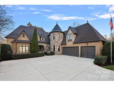 Stunning stone and shingle exterior of a luxurious home with a three-car garage at 18528 Nantz Rd, Cornelius, NC 28031