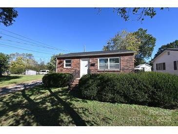 Charming brick home with well-maintained landscaping and a welcoming front entrance at 125 S Ervin Ave, Newton, NC 28658