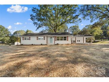 Charming renovated ranch home with white brick, craftsman-style shutters, and a lovely light blue front door at 3503 Linwood Rd, Gastonia, NC 28052