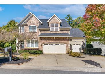 Charming stone-accented home featuring a three-car garage and well-manicured landscaping at 507 Quicksilver Trl, Fort Mill, SC 29708