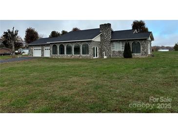 Stone house with a two-car garage and large yard at 2022 Friendship Church Rd, Taylorsville, NC 28681