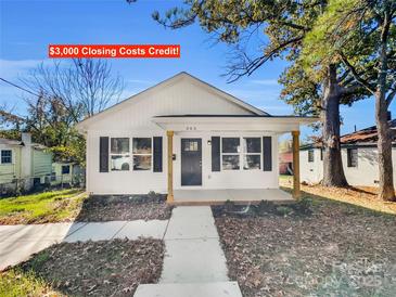 Charming white house with a front porch and landscaping at 305 Gooch St, Lancaster, SC 29720