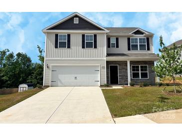 Charming two-story home with a two-car garage, stone accents, and a well-maintained lawn at 209 Lake George Dr, Shelby, NC 28152