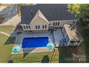 Aerial view of house, pool, deck, and surrounding landscape at 357 China Grove Rd, Kannapolis, NC 28083