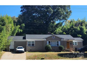 Charming brick home featuring a well-maintained front yard and a cozy, inviting entrance at 3337 Eastway Dr, Charlotte, NC 28205