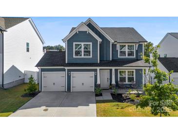 Two-story house with gray siding, two-car garage, and landscaping at 1547 Rye Rd, Mount Holly, NC 28120