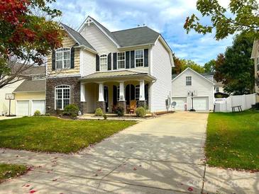 Two-story house with stone accents and a spacious driveway at 17420 Midnight Express Way, Cornelius, NC 28031