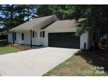 Charming one-story home with a black garage door and landscaped yard at 1969 Beth Haven Church Rd, Denver, NC 28037