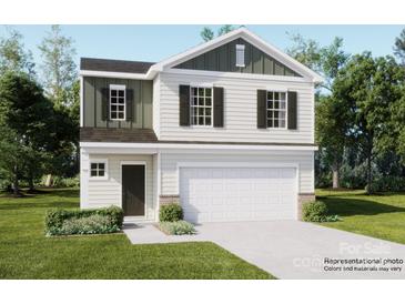 Two-story house with a white and green exterior, two-car garage, and landscaping at 117 Dorian Pl, Troutman, NC 28166