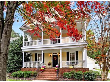 Two-story house with wraparound porch and brick steps, surrounded by fall foliage at 1360 Barnett Woods, Fort Mill, SC 29708