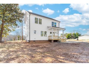 New two-story white home featuring a welcoming porch and unfinished landscaping at 150 Roxie Ln, Belmont, NC 28012