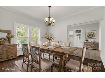 Bright dining room with farmhouse table and chandelier at 305 N White St, Lancaster, SC 29720