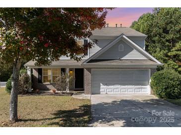 Charming two-story home with a well-manicured lawn and attached two-car garage, set against a backdrop of mature trees at 4707 Hannah Dr, Rock Hill, SC 29732