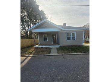 Charming, newly renovated single-story home with a covered porch and well-maintained yard at 401 Woodlawn Ave, Cramerton, NC 28032