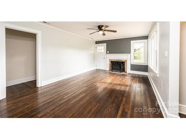 Bright living room features hardwood floors, fireplace, and neutral walls at 2186 W Nc 10 Hwy, Newton, NC 28658
