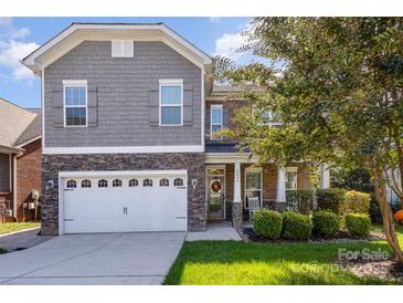 Two-story home with gray siding, stone accents, and a two-car garage at 2844 Georgia Ave, Charlotte, NC 28205