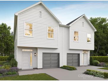 Two-story home featuring a modern exterior, gray garage doors, and beautiful landscaping at 9251 Eleanor Dr, Charlotte, NC 28214