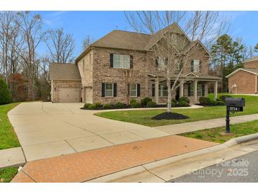 Two-story brick home with a three-car garage and landscaped yard at 2714 Stonewood Vw, Kannapolis, NC 28081