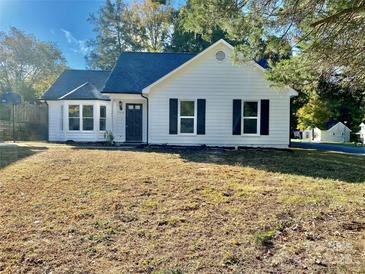 Charming home featuring a bay window, black shutters, and a well-maintained lawn at 4500 Doves Nest Ct, Matthews, NC 28105