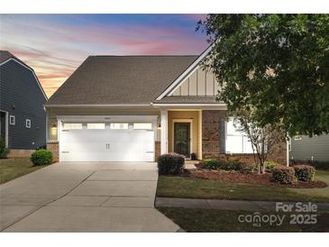 Charming single-story home with a two-car garage, well-maintained landscaping, and inviting entrance at 7095 Sunset Crater Pl, Lancaster, SC 29720