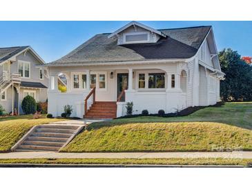 Charming craftsman home with white exterior, wood steps, and manicured lawn at 103 2Nd Nw Ave, Hickory, NC 28601