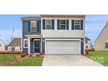 Two-story house with blue siding, white trim, and a two-car garage at 165 Smokey Way, Statesville, NC 28625