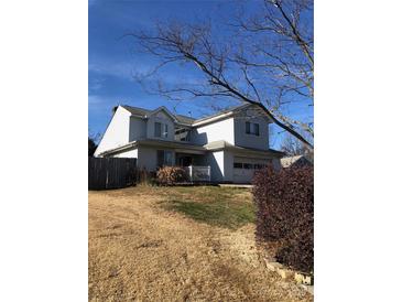 Two-story house with attached garage and manicured lawn at 8540 Indian Summer Trl, Harrisburg, NC 28075