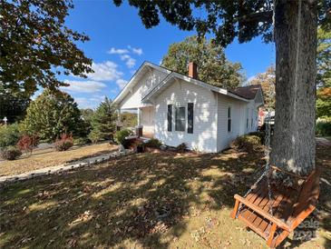 Charming white house with a tree-lined yard and swing at 203 E Cannon Ave, Albemarle, NC 28001