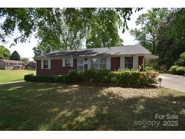 Charming brick home with a well-maintained lawn and mature trees in a desirable neighborhood at 2427 Rhyneland St, Gastonia, NC 28054