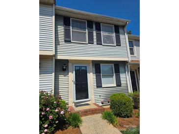 Charming two-story home with black shutters and well-maintained landscaping near the front door at 9424 Lexington Cir # F, Charlotte, NC 28213