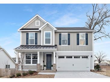 Two-story house with gray siding, metal roof, and a two-car garage at 2304 Catalina Ave, Charlotte, NC 28206