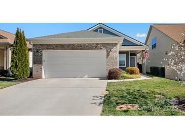 Charming home with a brick and siding exterior, neat landscaping, and an attached two-car garage at 6296 Raven Rock Dr # 725, Denver, NC 28037