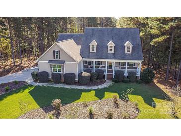 Charming home with a welcoming front porch, three dormer windows, and lush landscaping at 360 Lauren Pines Dr, York, SC 29745