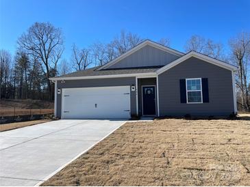 Gray exterior house with white garage door and blue front door at 404 Brinkley Dr # 141, Kings Mountain, NC 28086