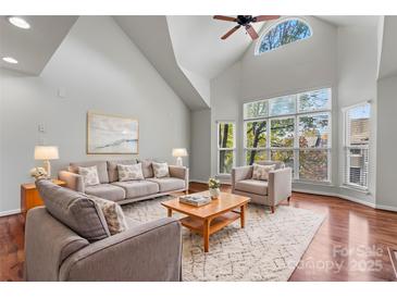 Spacious living room with hardwood floors, vaulted ceilings, and large windows at 513 N Graham St # 3D, Charlotte, NC 28202