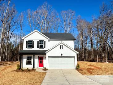 Two-story house with red door, white siding, and a gray roof at 737 E Memorial Hwy, Harmony, NC 28634