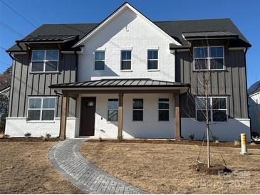 Charming new construction home featuring a brick walkway, light and dark siding, and a covered front porch at 809 Terra Dr, Tega Cay, SC 29708