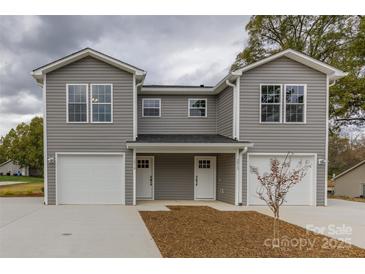 New gray townhome offers a front-entry two-car garage and covered front porch at 2014 Crown Point Dr # 2008-B, Albemarle, NC 28001