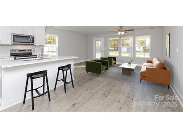 Open floor plan offers a smooth transition between the kitchen and well-lit living area at 2014 Crown Point Dr # 2008-B, Albemarle, NC 28001