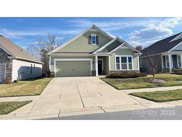 Charming single-story home featuring a well-manicured lawn and attached two-car garage at 126 E Northstone Rd, Mooresville, NC 28115